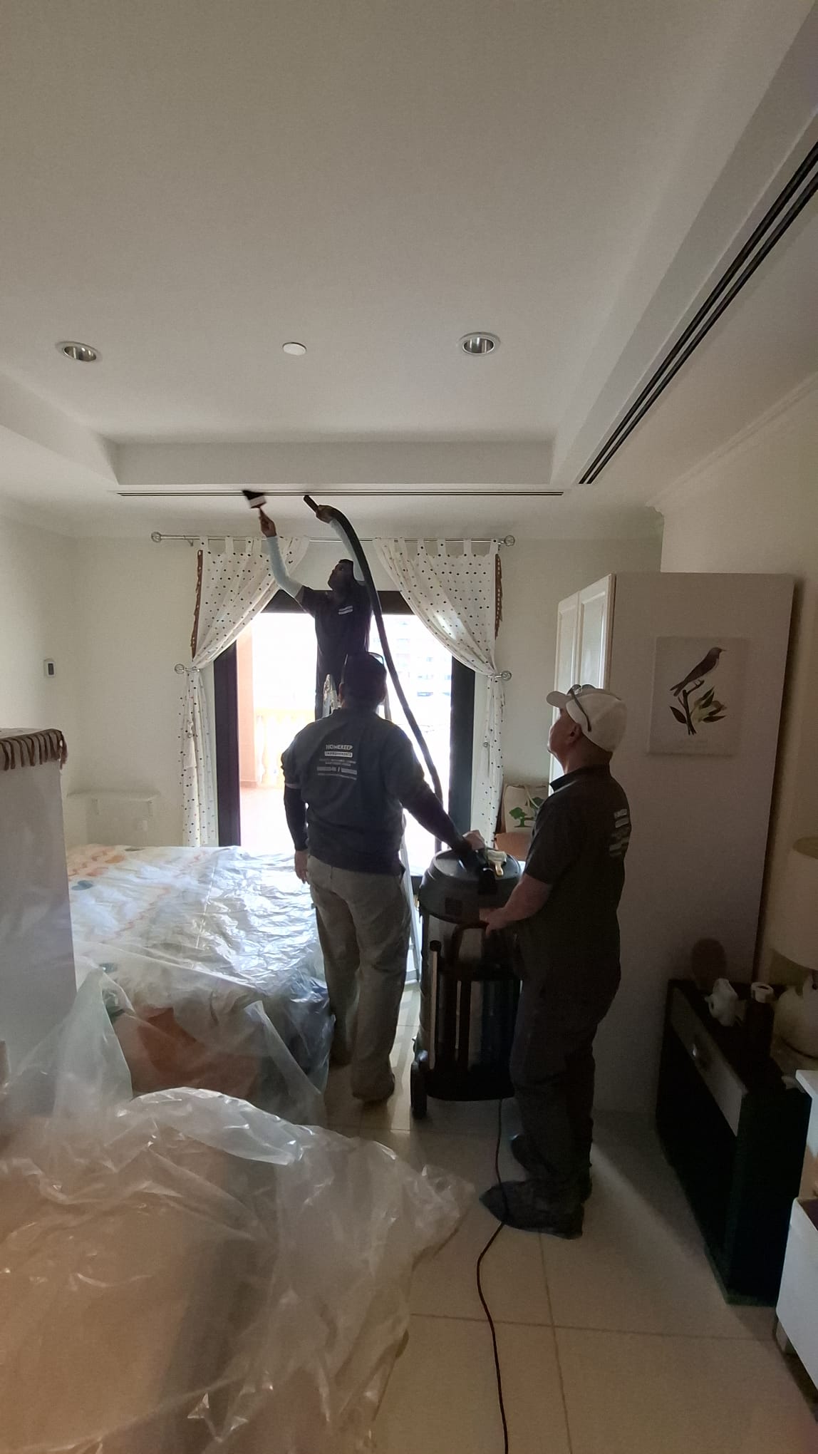 Homekeep technicians servicing villa HVAC — Qatar